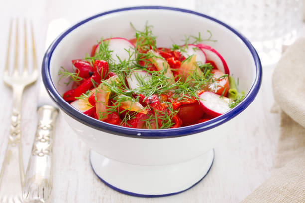 istock fresh vegetable salad on white dish on white wooden background 807419262