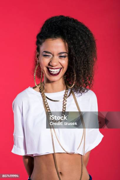 Happy Young Woman In Hiphop Style Against Red Background Stock Photo - Download Image Now