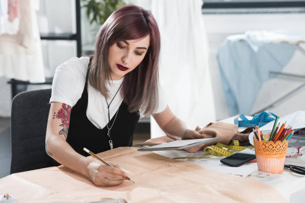 istock portrait of concentrated woman using digital tablet while sitting at workplace 807425318