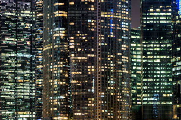 istock Glowing windows of skyscrapers at evening. Night cityscape 807425462