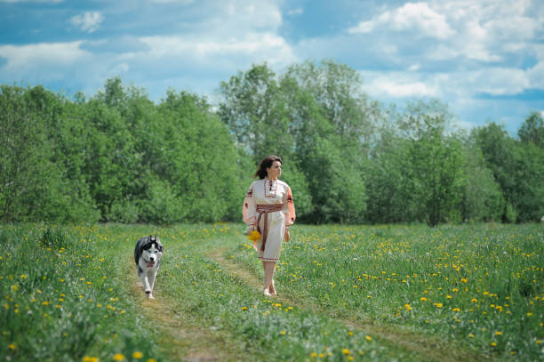 istock Young Slavic girl with a husky dog 807430748