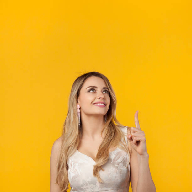 istock Stylish girl pointing up 807433034