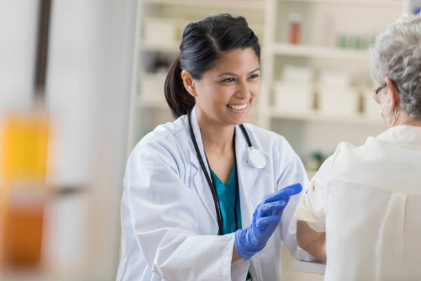 istock Smiling young pharmacist prepares senior customer for her flu shot 807443166