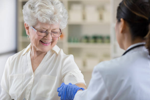 istock Senior pharmacy customer gets a band-aid after flu shot 807443180