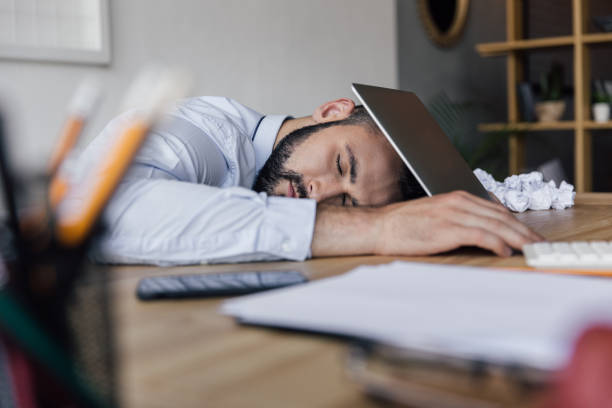 istock side view of tired businessman sleeping at workplace in office 807446270