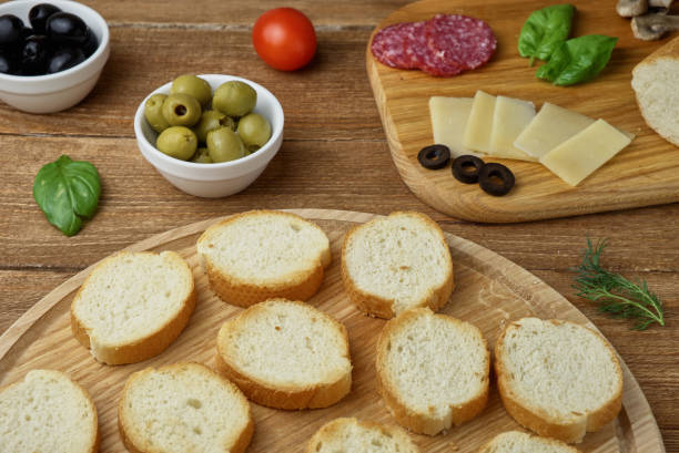 istock Delicious Crostini with different toppings on wooden background 807447170
