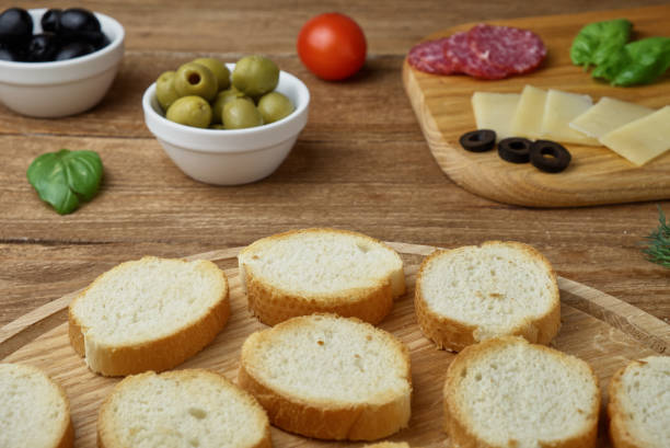 istock Delicious Crostini with different toppings on wooden background 807447178