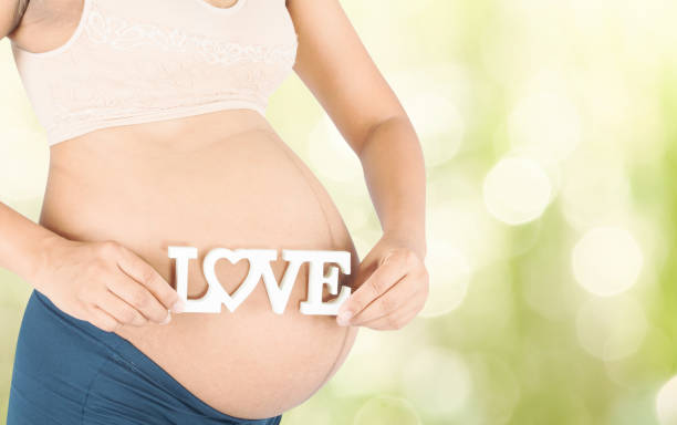 istock Pregnant woman hold text love 807448418