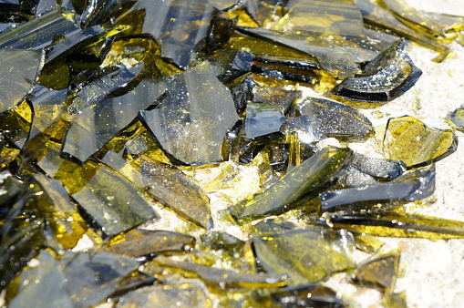 Brown and yellow broken glass in the rays of the bright sun