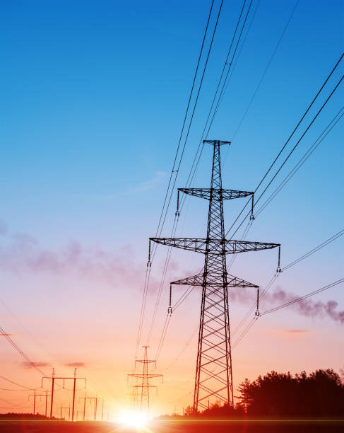 istock Energy Distribution Network - Electricity Pylons against Orange and Yellow Sunset. 807463534