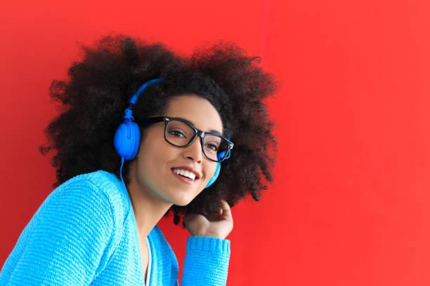 istock Smiling afro woman with blue headphones 807464096