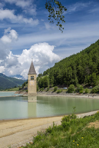 church tower of graun in the lago di resia, italy - grass church flood landscape imagens e fotografias de stock