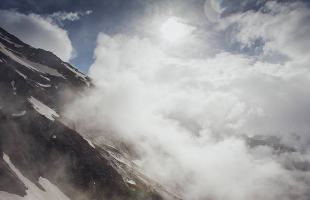istock Beautiful mountain landscape with snow in cloud 807470598
