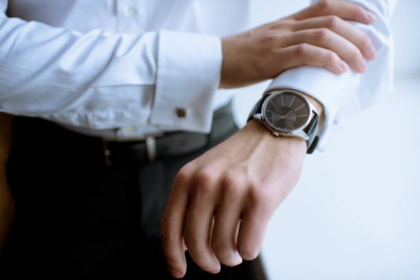 istock Groom is wearing a wrist watch indoors 807473250
