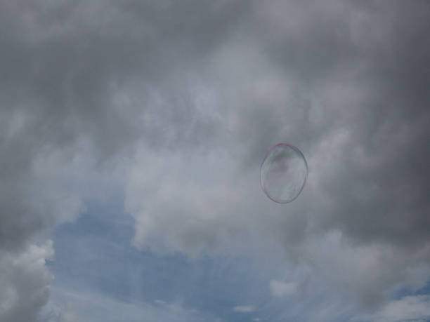 istock colorful soap bubbles in front of blue sky with clouds 807473624