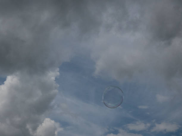 istock colorful soap bubbles in front of blue sky with clouds 807477426