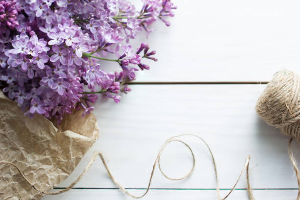 istock lilac flowers on white old wooden background 807479586
