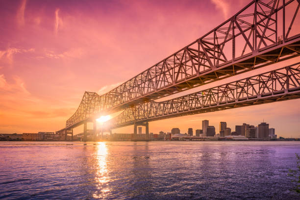 New Orleans, Louisiana, USA New Orleans, Louisiana, USA at Crescent City Connection Bridge over the Mississippi River during sunset. louisiana photos stock pictures, royalty-free photos & images