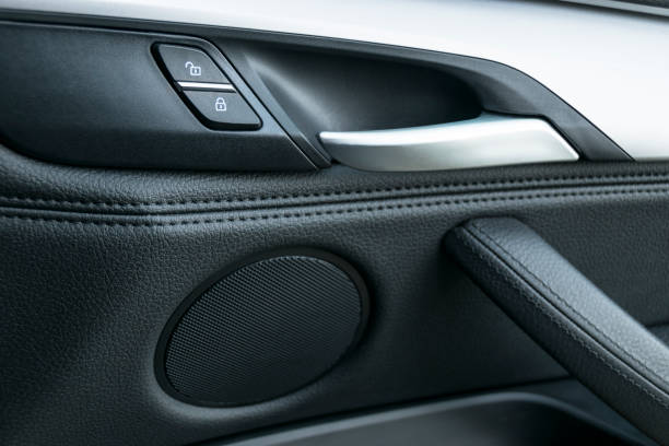 istock Car door handle inside the luxury modern car with black leather and switch button control, modern car interior details 807487592
