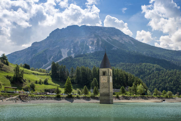 church tower of graun in the lago di resia, italy - grass church flood landscape imagens e fotografias de stock