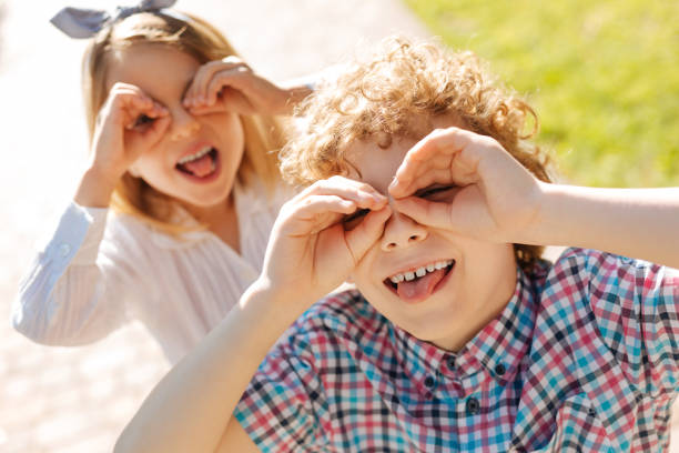 istock Positive children posing on camera with pleasure 807500378