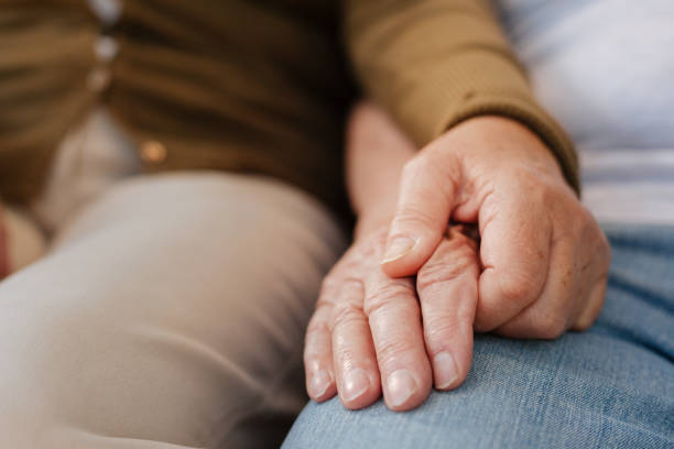 istock Close up of elderly married people while holding hands 807500554