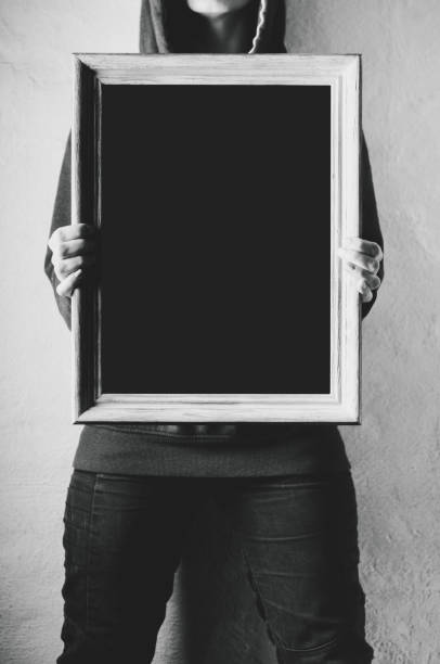istock Black canvas in the woman's hands. The place for the text or design on a canvas 807501276