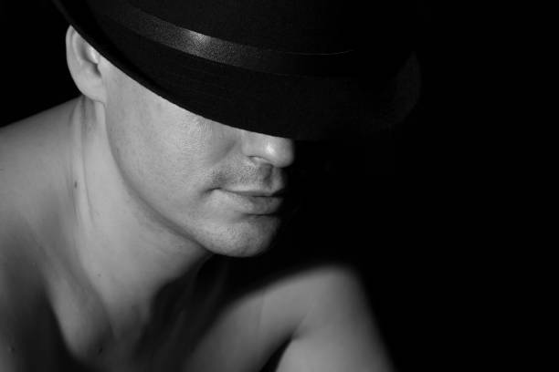 istock A man in a black hat with bare shoulders. Black and white. 807521720