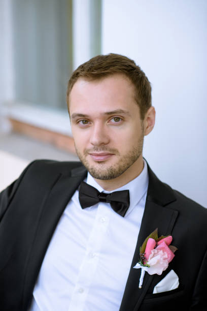 istock Handsome groom in suit in the nature 807529228