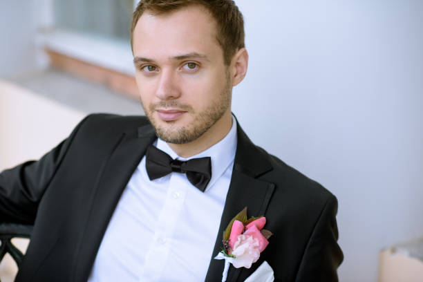 istock Handsome groom in suit in the nature 807529402