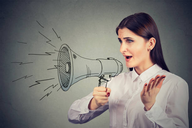 istock Woman making announcement with megaphone 807539490