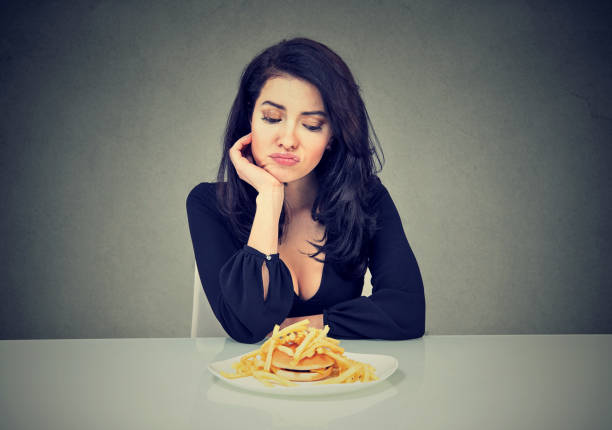 istock Sad woman on diet craving for fast food 807539672