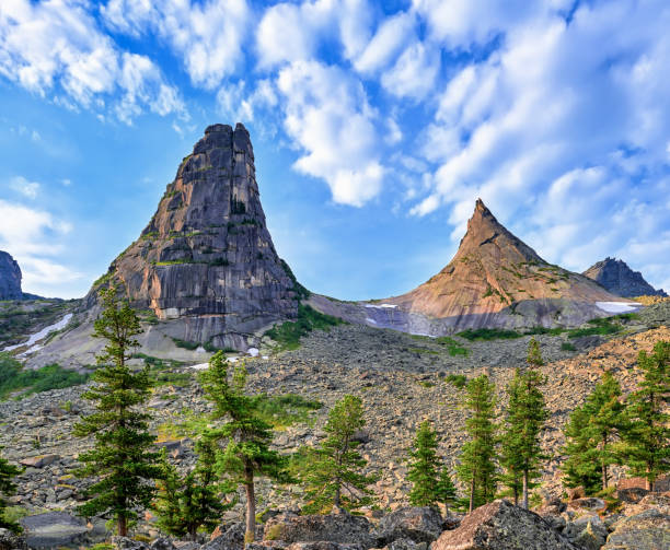 Two mountain peaks Two mountain peaks form bend in form of mathematical parabola. Rocks "The Brothers". Ergaki Ridge. Western Sayan. Russia parabola stock pictures, royalty-free photos & images