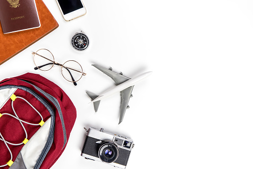 Backpacker travel accessories on white copy space