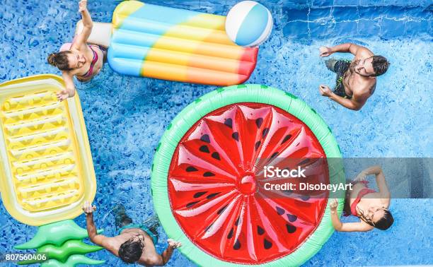 Happy Friends Playing With Ball Inside Swimming Pool Young People Having Fun On Summer Holidays Vacation Travelholidaysyouthfriendship And Tropical Concept Seasonal Color Tones Filter Stock Photo - Download Image Now