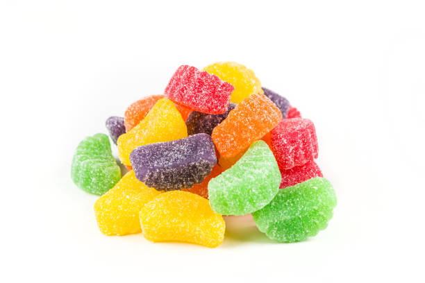 istock Rainbow colored gummy fruit slices isolated on a white background 807571416