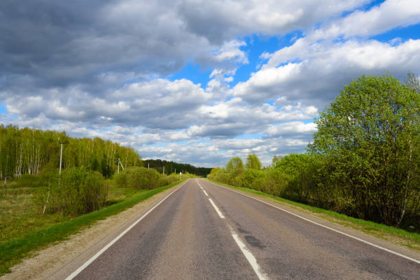 istock the road past  green meadows and woods 807573518