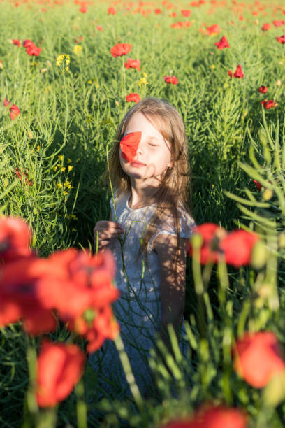 istock Girl with poppies 807600956