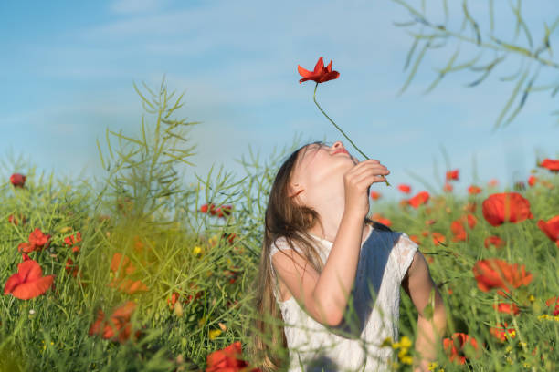 istock Girl with poppies 807630076