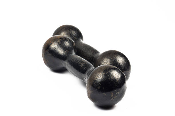 istock Two vintage cast iron black dumbbells stacked in parallel, on a white background 807660586