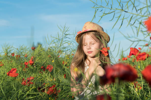 istock Girl with poppies 807661074