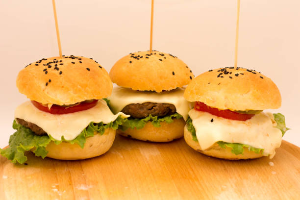 istock Tasty cheeseburgers on a wooden board 807661992