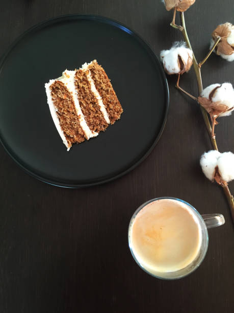 Carrot Cake, coffee and cotton plant.Top View on black background.