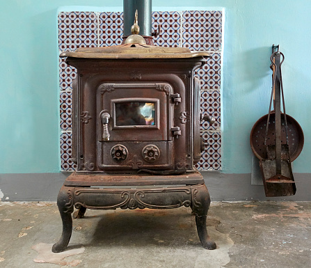 Cast iron stove, rusty but working in a rural home
