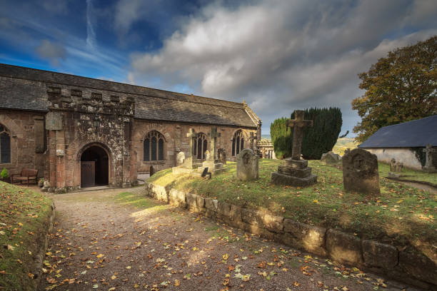 Courtyard of the Anglican Church. You can see old graves. Autumn evening. Clouds in the blue sky. Chagford. Devon. England