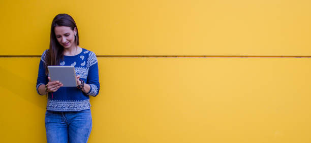 istock Cute looking girl with a digital tablet 807721090