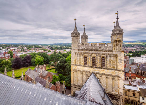 View of the city of Exeter from one of the towers of the cathedral View of the city of Exeter from one of the towers of the cathedral. Also one of the towers is visible in the foreground. Devon. England exeter england stock pictures, royalty-free photos & images