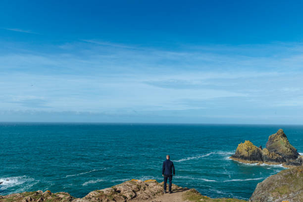 istock Man stood looking out over views of the South Cornish Coast. 807742152