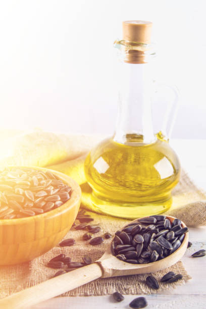 istock Sunflower seed and oils on wooden table. 807748046