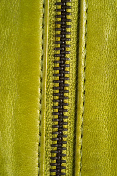 istock Green leather jacket zippers. Leather jacket macro details. Jacket zippers and pockets 807759426